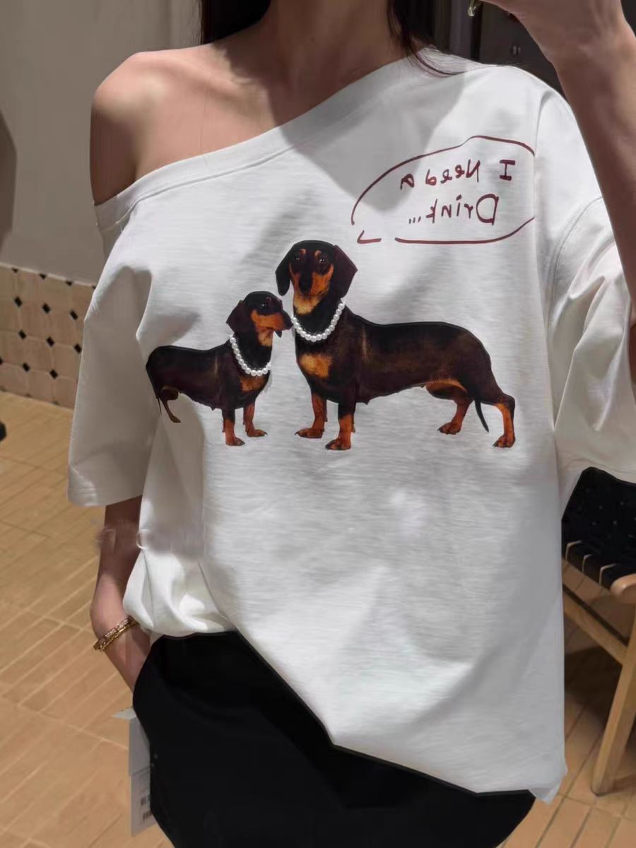 Slanted Off-Shoulder Short Sleeve T-Shirt for Women with Sausage Dog Print, Loose Fit, Jennie-Style, Versatile Casual Top Slanted Off-Shoulder Short Sleeve T-Shirt for Women with Sausage Dog Print, Loose Fit, Jennie-Style, Versatile Casual Top